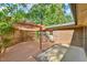 Outdoor wooden patio with overhead pergola beside a brick house at 308 Rainbow Dr, Carrboro, NC 27510