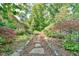 View of stone path and landscaping in beautiful backyard at 308 Rainbow Dr, Carrboro, NC 27510