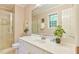 Bright bathroom featuring a shower, modern vanity, and ample counter space with a large mirror at 308 Rainbow Dr, Carrboro, NC 27510