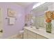 A well-lit bathroom featuring a large mirror, white cabinetry, and clean fixtures at 308 Rainbow Dr, Carrboro, NC 27510