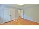 A light-filled bedroom featuring double closets, hardwood flooring and neutral paint colors at 308 Rainbow Dr, Carrboro, NC 27510