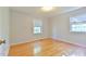 Clean, light filled bedroom with hardwood floors and a modern window at 308 Rainbow Dr, Carrboro, NC 27510