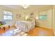 Cozy bedroom featuring two windows, neutral walls, and hardwood floors at 308 Rainbow Dr, Carrboro, NC 27510