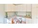 Desk area with seating, custom cabinetry, drawers, and pegboard backsplash at 308 Rainbow Dr, Carrboro, NC 27510