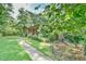 Landscaped front yard featuring a brick home and a brick walkway at 308 Rainbow Dr, Carrboro, NC 27510