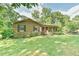 Brick home with a well-kept lawn, mature landscaping, and a brick walkway at 308 Rainbow Dr, Carrboro, NC 27510
