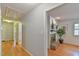 Hallway view leading to a living area, showcasing hardwood floors and access to other rooms at 308 Rainbow Dr, Carrboro, NC 27510