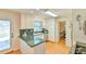 Updated kitchen with stainless dishwasher, white cabinets and natural light from the glass door at 308 Rainbow Dr, Carrboro, NC 27510