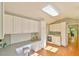 Bright laundry room with washer, dryer, built in desk, and custom cabinetry at 308 Rainbow Dr, Carrboro, NC 27510