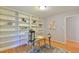 A dedicated office space featuring custom built-in bookshelves and a well-lit desk area at 308 Rainbow Dr, Carrboro, NC 27510