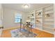 A dedicated office space featuring custom built-in bookshelves and a well-lit desk area at 308 Rainbow Dr, Carrboro, NC 27510