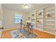 A dedicated office space featuring custom built-in bookshelves and a well-lit desk area at 308 Rainbow Dr, Carrboro, NC 27510