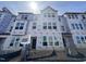 Three-story townhome under construction showcasing multiple windows and modern architectural design at 323 Chesapeake Cmns St # 104, Garner, NC 27529