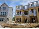 A new construction home with exposed framing, sheathing, and stacked lumber, ready for the next phase of building at 335 Chesapeake Cmns St # 107, Garner, NC 27529