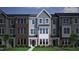 Charming exterior view of townhomes featuring a mix of siding and brick accents, enhancing the neighborhood's curb appeal at 335 Chesapeake Cmns St # 107, Garner, NC 27529