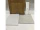 Sample of design materials that includes brown cabinets, white countertops, light tile, and dark tile at 335 Chesapeake Cmns St # 107, Garner, NC 27529