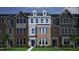 Charming new construction townhome with brick facade, gray siding, and meticulously maintained front yard at 339 Chesapeake Cmns St # 108, Garner, NC 27529