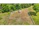 Aerial view of a fenced backyard with a shed, offering a secure outdoor space for various activities at 3409 Lemon Springs Rd, Sanford, NC 27332