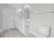 Bright bathroom with double sink vanity, decorative mirrors, and a neutral color palette at 3409 Lemon Springs Rd, Sanford, NC 27332