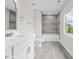 Modern bathroom featuring a large vanity, sleek tile work, and natural light at 3409 Lemon Springs Rd, Sanford, NC 27332