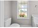 Powder room features updated vanity, view from a window, and new toilet at 3409 Lemon Springs Rd, Sanford, NC 27332