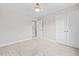 Bedroom featuring carpet, light paint and trim, and a large closet with double doors at 3409 Lemon Springs Rd, Sanford, NC 27332