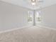 A bright bedroom features two windows, neutral walls and plush carpeting at 3409 Lemon Springs Rd, Sanford, NC 27332