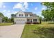 Charming two-story home boasts a well-manicured lawn, attached garage, and inviting front porch at 3409 Lemon Springs Rd, Sanford, NC 27332