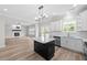 Kitchen with black island and stainless-steel appliances; open to the living area at 3409 Lemon Springs Rd, Sanford, NC 27332