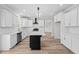 Bright kitchen with white cabinetry, central island, stainless appliances and eat-in dining at 3409 Lemon Springs Rd, Sanford, NC 27332