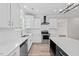 Bright kitchen with white cabinetry, black island, stainless appliances and quartz countertops at 3409 Lemon Springs Rd, Sanford, NC 27332