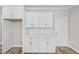 Kitchen space featuring white cabinets, countertops, stainless hardware, and an entry door at 3409 Lemon Springs Rd, Sanford, NC 27332