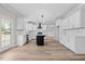 Modern kitchen featuring white cabinets, black island, and stainless steel appliances at 3409 Lemon Springs Rd, Sanford, NC 27332
