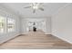 Bright, open living area with hardwood floors, ceiling fan and kitchen view at 3409 Lemon Springs Rd, Sanford, NC 27332