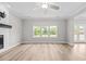 Bright and airy living room with a cozy fireplace, large windows, and seamless access to the backyard at 3409 Lemon Springs Rd, Sanford, NC 27332