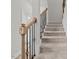 Carpeted staircase featuring wood and iron railing details leads to the upper level at 3409 Lemon Springs Rd, Sanford, NC 27332
