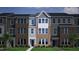 A townhome displays a color scheme of gray siding, brick, and white trim, emphasizing modern architectural design at 347 Chesapeake Cmns St # 110, Garner, NC 27529