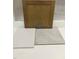 Design studio close-up showing white tile, tan kitchen cabinet, and light-colored stone flooring at 347 Chesapeake Cmns St # 110, Garner, NC 27529