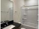 Bathroom features a shower and bathtub combo, black granite counters, and sleek mirror at 38 Gander Dr, Benson, NC 27504