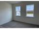 Cozy bedroom with carpeted floors, two windows, and great natural light at 38 Gander Dr, Benson, NC 27504