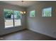 Dining room features wood floors, large windows, and elegant lighting fixture at 38 Gander Dr, Benson, NC 27504