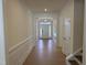 Bright hallway features elegant trim, wood floors and a view of the front door at 38 Gander Dr, Benson, NC 27504