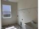 Spacious laundry room features a sink, overhead shelving and one window at 38 Gander Dr, Benson, NC 27504