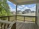 A wooden deck offers views of neighboring homes and backyard space, perfect for outdoor relaxation and entertaining at 42 Hemming Ct, Cameron, NC 28326