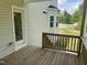 A wooden deck overlooks a green backyard and offers a relaxing outdoor space with access to the home through a glass door at 42 Hemming Ct, Cameron, NC 28326