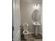 Powder room featuring an oval mirror, pedestal sink, and tile floors at 42 Hemming Ct, Cameron, NC 28326