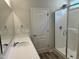 Well-lit bathroom with a shower, door, vanity with sink, and a large mirror at 42 Hemming Ct, Cameron, NC 28326