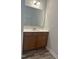 Bathroom features vanity with sink, large mirror, and wood-look floors at 42 Hemming Ct, Cameron, NC 28326