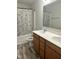 Bathroom featuring a double vanity, shower-tub combo with patterned curtain at 42 Hemming Ct, Cameron, NC 28326