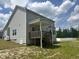 Exterior view of a two-story home with a covered back porch and a spacious green yard, ideal for outdoor activities at 42 Hemming Ct, Cameron, NC 28326